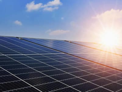 Solar panels with sunset and blue sky background. Clean power energy concept